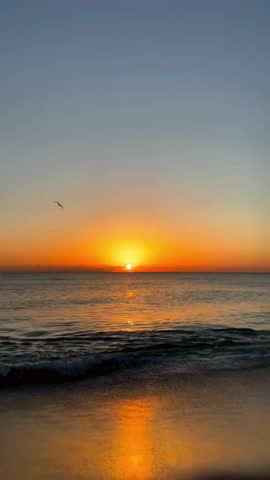 Capturing the serene scene of a calm beach during sunset