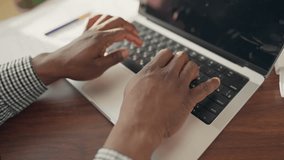 Unrecognizable internet user surfing websites, close-up view of black man hands. IT specialist, programmer or hacker using laptop, typing text on keyboard, programming and coding, freelancer with PC - Powered by Shutterstock - Get 15% off with code: PIKWIZARD15