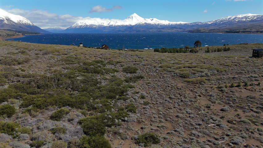 Stunning view of Huechulafquen lake shoreline and snow covered Lanín Volcano in Patagonia, Neuquén, Argentina