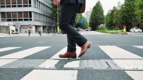 Businessman, legs and crossing street in city for travel, journey and morning commute to work. Japanese person, feet and walking route on Tokyo road with commitment, steps and eco conscious employee - Powered by Shutterstock - Get 15% off with code: PIKWIZARD15