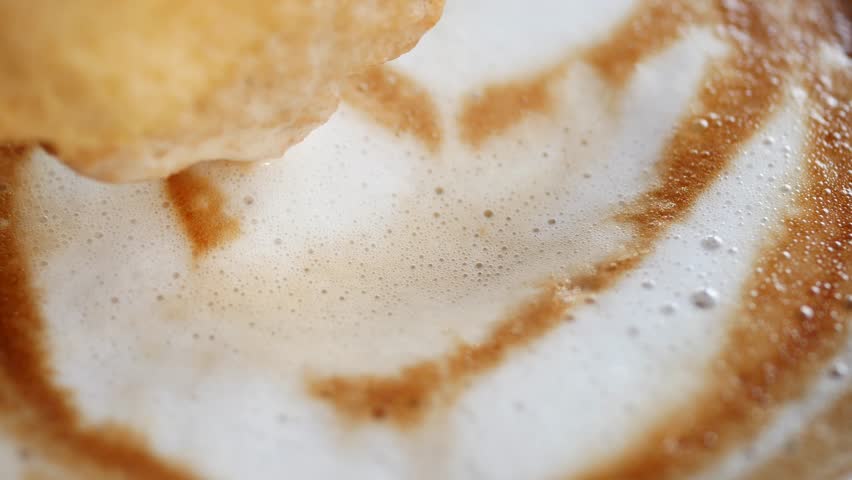 Dunking a Delicious Biscuit into a Warm and Inviting Cup of Freshly Brewed Coffee