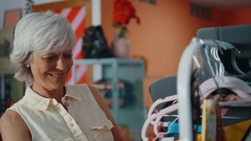 Senior woman selling clothes and accessories online with a selling app from home. - Powered by Shutterstock - Get 15% off with code: PIKWIZARD15