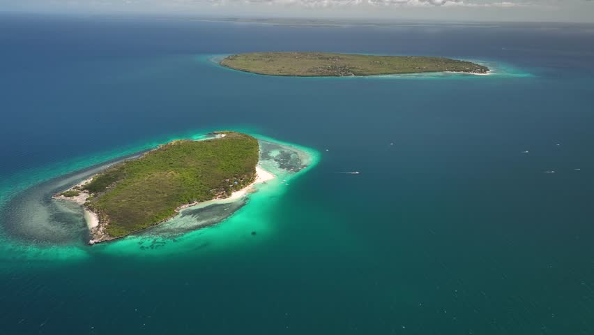 Virgin island with hilantagaan island in the distance surrounded by clear blue waters, aerial view