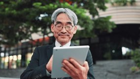 Mature business man, tablet and city with texting, reading and excited for notification on travel to work. Person, touchscreen and happy with app, contact or booking taxi on urban sidewalk in Japan - Powered by Shutterstock - Get 15% off with code: PIKWIZARD15