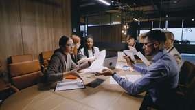 A collaborative team meeting takes place in a modern office environment, fostering an atmosphere of open discussion and effective communication among employees and managers - Powered by Shutterstock - Get 15% off with code: PIKWIZARD15