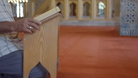 muslim man hand holding Holy book Quran at mosque  - Powered by Shutterstock - Get 15% off with code: PIKWIZARD15