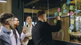 Collaboration in Action A dynamic team engaging in discussion, brainstorming novel ideas on colorful sticky notes within a modern office space designed for productivity and creativity - Powered by Shutterstock - Get 15% off with code: PIKWIZARD15