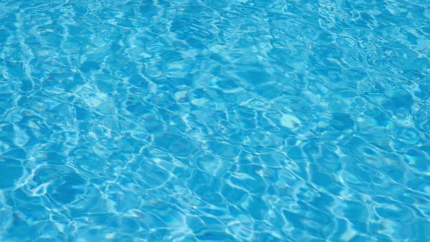 Blue Water Pool Surface with Sunlight Reflections
