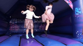 4K: Young Girls bouncing in the sun on a Bouncy Castle Bounce house Outdoors in summer.  Stock Video Clip Footage - Powered by Shutterstock - Get 15% off with code: PIKWIZARD15