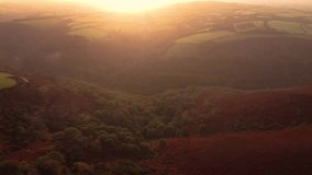 Sunrise Sun Flare Aerial View Over Exmoor Farm Fields with Rolling Hills and Trees Deep in the Valley. Golden Hour Spiritual Travel Footage 4K. - Powered by Shutterstock - Get 15% off with code: PIKWIZARD15