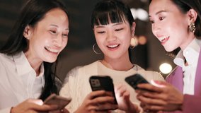 Japanese women, phone and city for night travel with social media, happy news or information. Friends, talk and laughing with smartphone for networking, funny meme or train schedule search in Tokyo - Powered by Shutterstock - Get 15% off with code: PIKWIZARD15