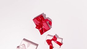 Many Christmas gift boxes with red ribbon on pink background. Stop motion animation. Space for text. Mockup. - Powered by Shutterstock - Get 15% off with code: PIKWIZARD15