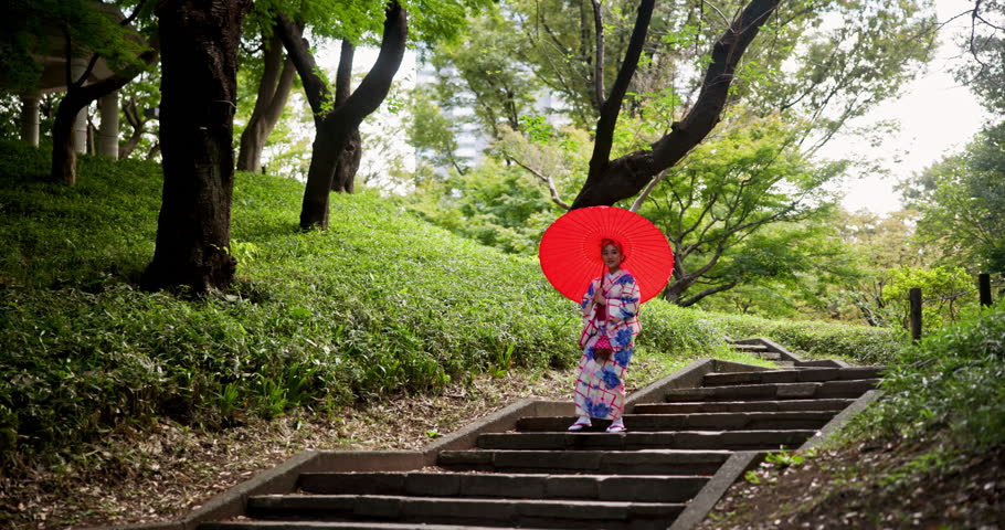 Japanese, stairs and woman with umbrella, walking and nature with adventure, travel and tourism. Person, outdoor and girl in park, traditional clothes and culture with steps, fashion and parasol