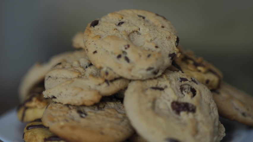 Close-up of Group of Assorted Cookies. Chocolate Chip, Oatmeal Raisin, White Chocolate Fill Frame. Cookies With Pieces of Chocolate, Rotation. Junk Food Diabetes Carbohydrates Unhealthy Diet.