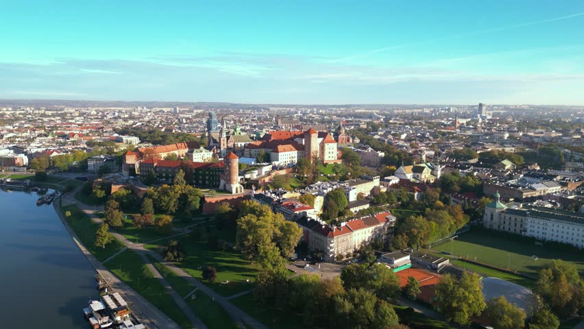 High angle shot of Wawel Royal Castle in Krakow, Poland. Footage oof Zamek Królewski na Wawelu in Cracow seen from the air. Classical Crowning place of all Polish kings. Cityscape during sunrise.