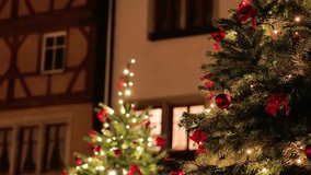 Christmas town background. Soft focus. Christmas balls on tree branches and sparkling decorated houses in blur.Christmas street decor in a European city.Glowing Christmas street decorations. 4k - Powered by Shutterstock - Get 15% off with code: PIKWIZARD15