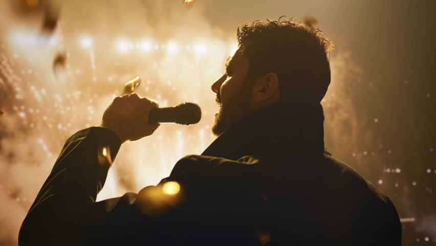 Silhouetted Singer Performing On Stage With Dramatic Pyrotechnic Light Show Performance Entertainment Concert