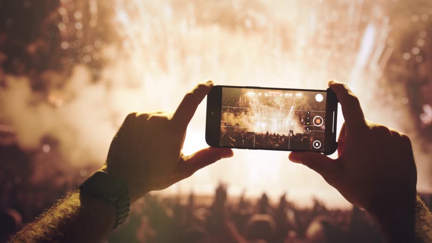 Hands Recording Concert Fireworks Display On Smartphone Device At Night Entertainment - Powered by Shutterstock - Get 15% off with code: PIKWIZARD15