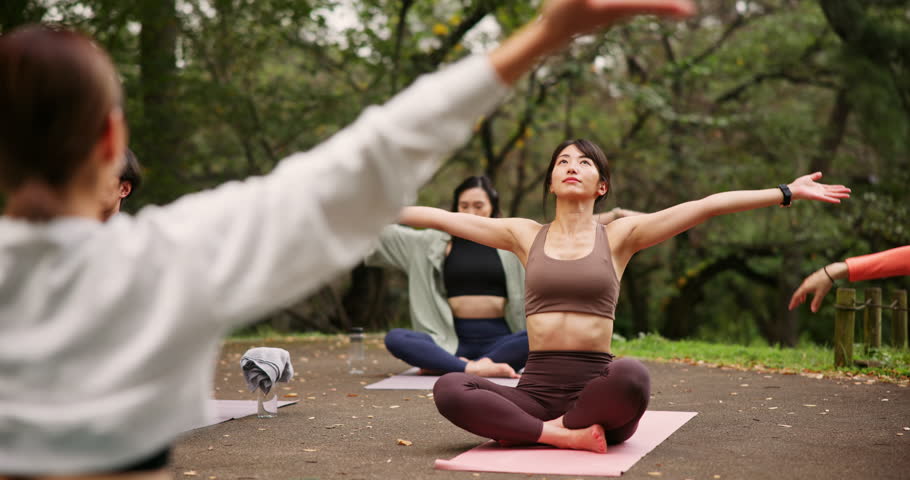 Asian woman, nature or yoga class with balance for meditation, zen or spiritual wellness together. Japanese, female person or group with teacher for awareness exercise or inner peace on mat in forest