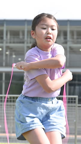 Vertical video of girls jumping rope in school yards, etc.	