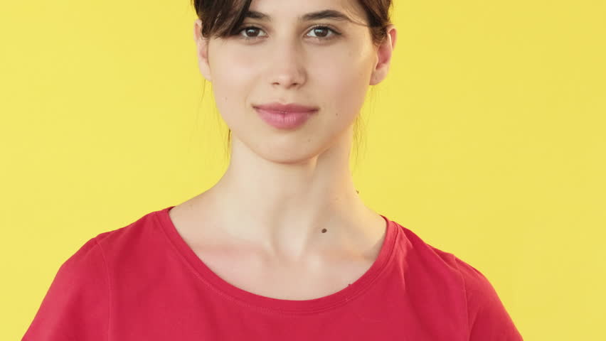 Heart symbol. Air kiss. Woman showing love heartfelt adore amour hand gestures affectionate body language isolated on yellow free space background.