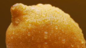 Lemon with water drops on orange background. Slow motion.  - Powered by Shutterstock - Get 15% off with code: PIKWIZARD15