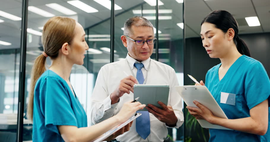 Asian people, doctor and team with tablet for nursing internship, coaching or staff training at hospital. Japanese, medical professional or mentor with technology, nurses or interns for clinic lesson