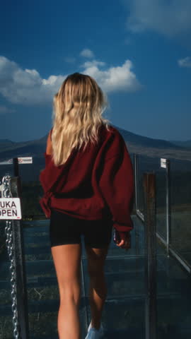 Attractive woman at the observation point. A trip to Bali. Batur volcano. A beautiful girl runs to watch the mountain. Adventures in Indonesia