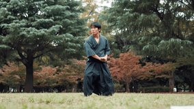 Bamboo sword, Kendo and Japanese man in nature for martial arts, fitness and fighting technique. Woods, Samurai and male person with katana fencing outdoor in park for traditional practice or skill. - Powered by Shutterstock - Get 15% off with code: PIKWIZARD15