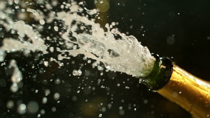 Super slow motion of Champagne explosion with flying cork closure, opening champagne bottle closeup, camera movement. Filmed on high speed cinematic camera at 1000 frames per second.