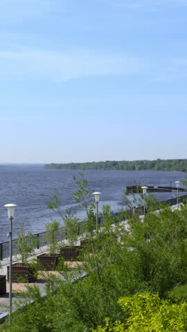 A scenic riverside pathway surrounded by greenery, ideal for relaxation and exploration. Clip