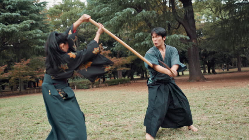 Bamboo, aikido and Japanese people in fight for martial arts, culture or traditional sports in forest. Wood sword, samurai and practice for training, duel partner and challenge to battle with outdoor