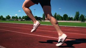 Close up legs Young man wearing sportswear running on track at sport stadium. Fit man jogging outdoor cross the finish line. Exercise in the morning. Healthy and active lifestyle concept. - Powered by Shutterstock - Get 15% off with code: PIKWIZARD15