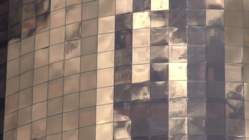 Reflections in Windows. Quickly running clouds reflected in the windows of a skyscraper. Time lapse