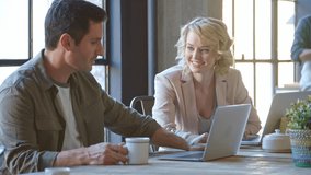 Group of businessmen and businesswoman using laptops having informal meeting in busy coffee shop - shot in slow motion - Powered by Shutterstock - Get 15% off with code: PIKWIZARD15