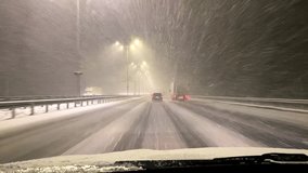 View from inside car window,windscreen,windshield driving on road in evening at heavy snowstorm blizzard at winter.navigation,route,vehicle riding,transportation,travel destinations.Europe - Powered by Shutterstock - Get 15% off with code: PIKWIZARD15