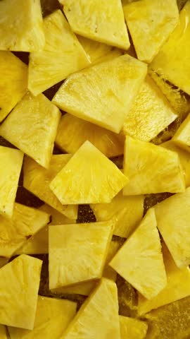 Super Slow Motion Shot of Splashing Fresh Pineapple Pieces . Filmed on High Speed Cinematic Camera at 1000fps .