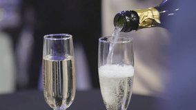 Waiter pours champagne into a glass at a buffet table - Powered by Shutterstock - Get 15% off with code: PIKWIZARD15