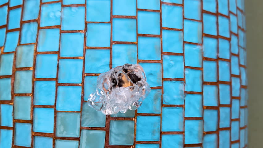 Hot thermal water gushes from the spring and flows down the pool on the thermal resort, top view. The concept of spa, wellness, relaxation. Hot springs