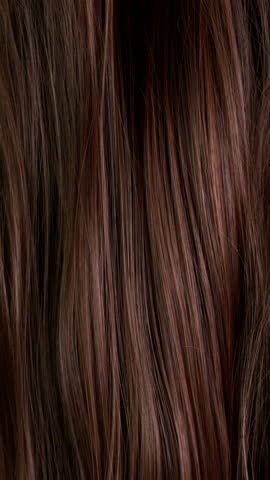 Super slow motion of beautiful healthy long smooth flowing brown hair. Filmed on high speed cinematic camera at 1000 fps.