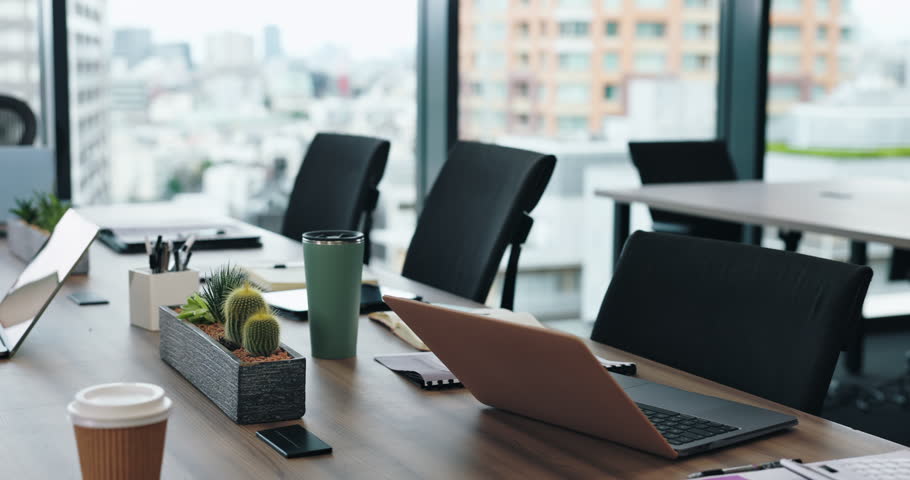 Empty office, tech on table and meeting room in company for seminar, conference and business planning. Furniture, documents and laptops in Japanese agency for finance management, training or workshop