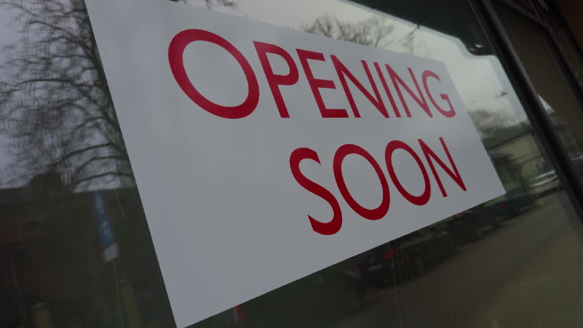 Storefront Signage Announcement for Opening Soon in a Dynamic Urban Setting Filled with Anticipation and Excitement