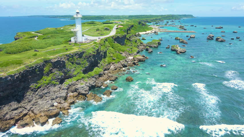 Cinematic aerial flyover of Hennasaki Lighthouse in Miyakojima Island in Okinawa, Japan