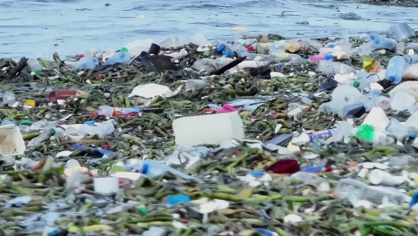 The ocean waves carry a significant amount of plastic waste, highlighting the extent of marine pollution. Striking footage for environmental awareness and sustainability campaigns.
