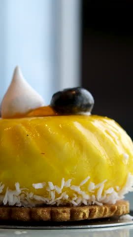 orange cheesecake Mousse orange cake, creamy dessert close-up. Almond dacquoise, raspberry confit, crispy layer with caramelized hazelnuts and raspberry powder, mousse based on bitter chocolate.