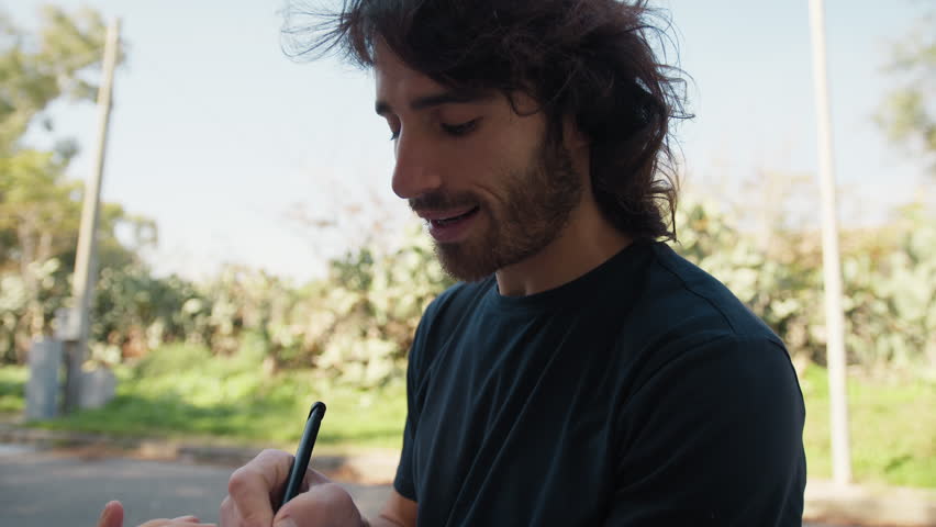 Long Haired Man Takes Notes Smiling Taking Surveys of Passers-by on the Street