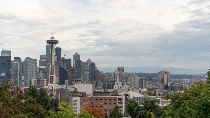 Time Lapse City of Seattle Downtown Cityscape Skyline The Space Needle and Mount Rainier on The Background from Kerry Park During Cloudy Day Washington State USA