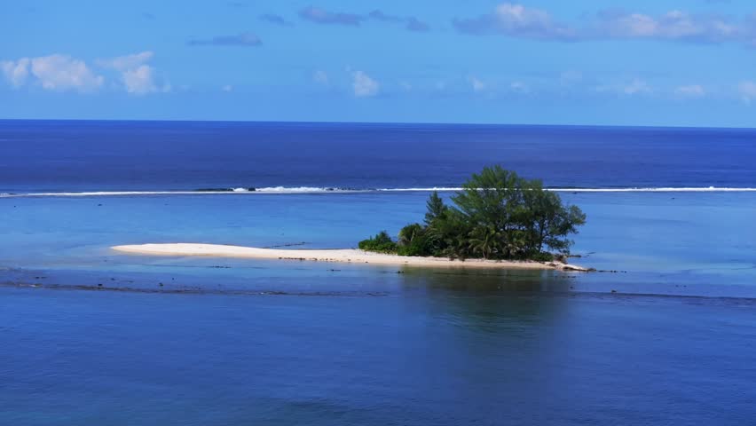 Single island Papeete Tahiti Tapahi Moto Au Mahina Orafara Ahonu French Polynesia aerial drone turquoise water clear waves barrier coral reef white sandy beach palm trees swim snorkel static shot