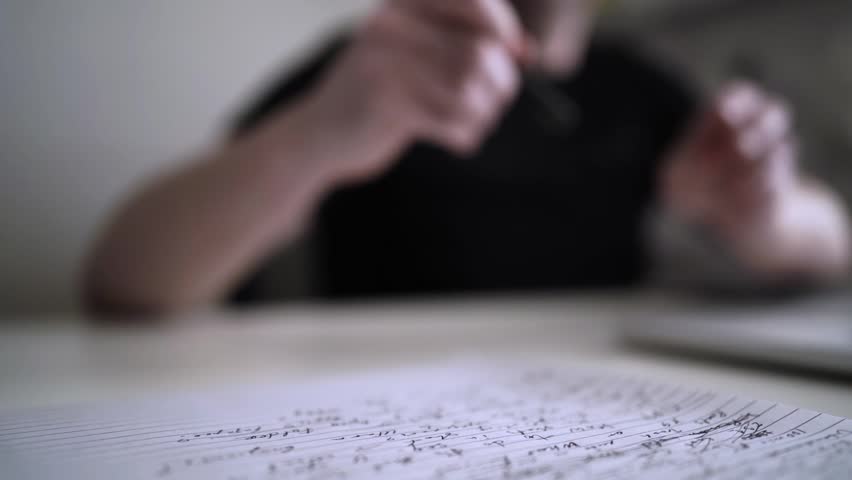Man journaling thoughts into notebook