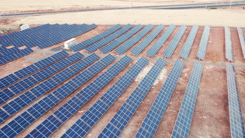 Aerial view of solar panel farm. Solar power station aerial view. Rows of solar photovoltaic panels. PV module farm in a desert. Solar energy farm high angle aerial view